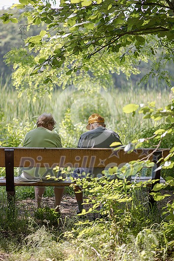 Elderly couple outdoors in summer. Happy elderly couple on a walk. Handsome man and woman senior citizens. Husband and wife of old age against the background of nature. Elderly couple outdoors in summer. Happy elderly couple on a walk. Handsome man and woman senior citizens. Husband and wife of old age against the background of nature.