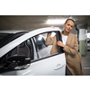 Underground parking/garage (shallow DOF; color toned image) - young woman with her car in the underground parking
