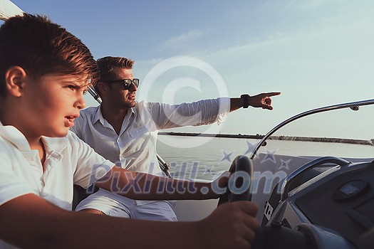 Father and son enjoy their vacation together while riding a luxury boat at sea. Selective focus. High-quality photo Father and son enjoy their vacation together while riding a luxury boat at sea. Selective focus. High-quality photo