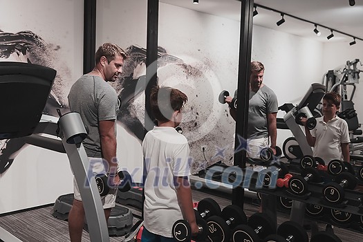 Father and son train together at home gym. The concept of healthy life. Selective focus. High-quality photo Father and son train together at home gym. The concept of healthy life. Selective focus. High-quality photo