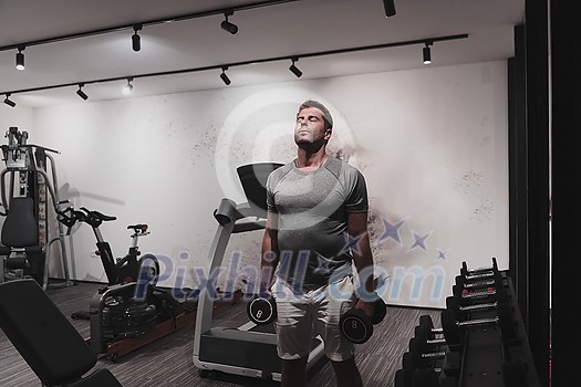 Struggling with age. Confident senior man exercising with dumbbells in the health club. Selective focus. High-quality photo Struggling with age. Confident senior man exercising with dumbbells in the health club. Selective focus. High-quality photo