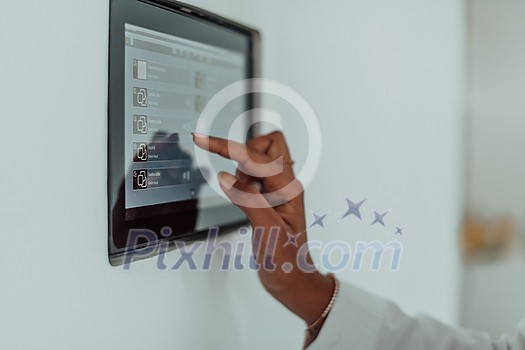 African woman using a smart home screen control system. High-quality photo African woman using a smart home screen control system. High-quality photo