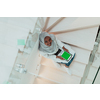 Young African modern Muslim woman using tablet computer while sitting on the stairs at home wearing hijab clothes top view. High-quality photo