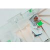 Young African modern Muslim woman using tablet computer while sitting on the stairs at home wearing hijab clothes top view. High-quality photo