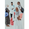 African female student with a group of friends in the background wearing traditional Islamic hijab clothes. Selective focus. High-quality photo