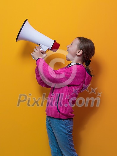 Funny little kid girl Screaming in megaphone over the yellow background in studio. People sincere emotions lifestyle concept. Mock up copy space. High quality photo Funny little kid girl Screaming in megaphone over the yellow background in studio. People sincere emotions lifestyle concept. Mock up copy space. High quality photo