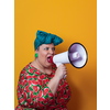 Funny plus size woman posing isolated on yellow background studio portrait. Overweight lady screaming in a megaphone. People emotions lifestyle concept. Mock up copy space. High quality photo