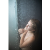 Pretty,young woman taking a long hot shower in a modern bathroom