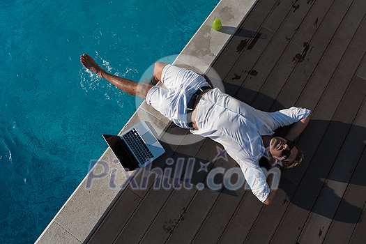 A modern senior man in casual clothes enjoys a vacation in an expensive house. Selective focus. High-quality photo A modern senior man in casual clothes enjoys a vacation in an expensive house. Selective focus. High-quality photo
