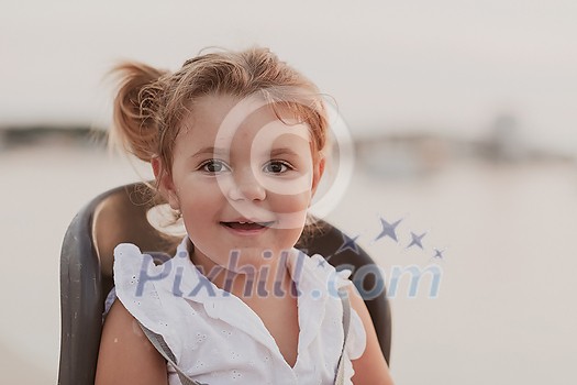 A portrait of a smiling little girl sitting in a bicycle seat. Selective focus. High-quality photo A portrait of a smiling little girl sitting in a bicycle seat. Selective focus. High-quality photo
