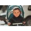 Sweet baby boy tow years old in a stroller bicycle outdoors. Little child in a pram. Infant kid in a pushchair. Spring walks with kids. High quality photo