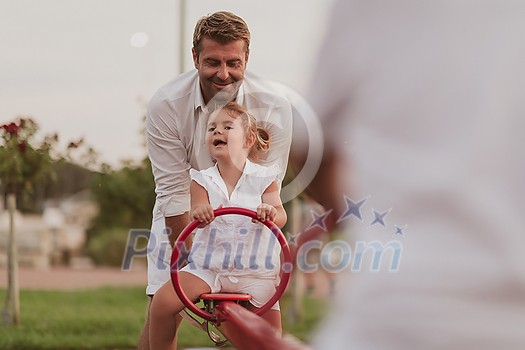 An elderly man in casual clothes with his daughter spends time together in the park on vacation. Family time. Selective focus. High-quality photo An elderly man in casual clothes with his daughter spends time together in the park on vacation. Family time. Selective focus. High-quality photo