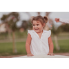 A little girl in modern summer clothes playing in the park in summer. Selective focus. High-quality photo