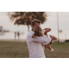 An elderly man in casual clothes with his daughter spends time together in the park on vacation. Family time. Selective focus. High-quality photo