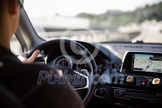 Driver at a steering wheel of a modern car (shallow DOF; color toned image) Driver at a steering wheel of a modern car (shallow DOF; color toned image)