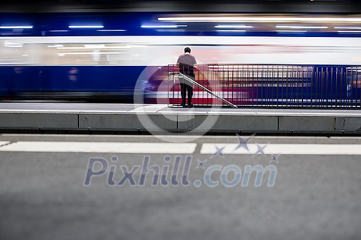 People in a trainstation with motion blurred trains moving fast (color toned image) People in a trainstation with motion blurred trains moving fast (color toned image)