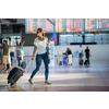 Young woman with her luggage at an international airport, before going through the check-in and the security check before her flight