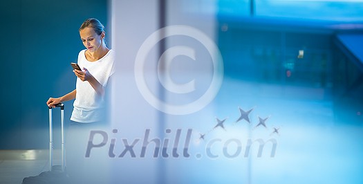 Young woman with her luggage at an international airport, before going through the check-in and the security check before her flight Young woman with her luggage at an international airport, before going through the check-in and the security check before her flight