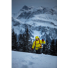 Young man snowshoeing in high mountains, enjoying splendid winter weather with abundance of snow