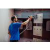 The painter paints the iron element. Industrial painting parts. Metal designs. High-quality photo