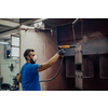 The painter paints the iron element. Industrial painting parts. Metal designs. High-quality photo