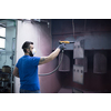 The painter paints the iron element. Industrial painting parts. Metal designs. High-quality photo