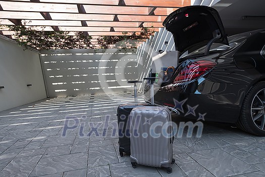 A photo of a suitcase standing next to a car in a luxury garage. High-quality photo