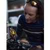 Industrial worker man soldering cables of manufacturing equipment in a factory. Selective focus. High quality photo