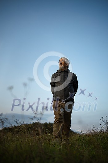 Senior man enjoying the outdoors, hiking, walking throught lovely nature Senior man enjoying the outdoors, hiking, walking throught lovely nature
