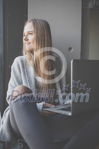 Pretty, young woman with her laptop studying for an exam/working Pretty, young woman with her laptop studying for an exam/working