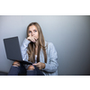 Pretty, young woman with her laptop studying for an exam/working