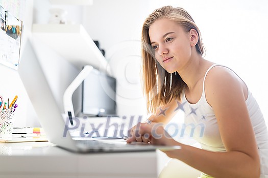 Teenage girl homeschooled due to COVID pandemics, following online classes Teenage girl homeschooled due to COVID pandemics, following online classes