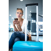 Young woman with her luggage at an international airport, before going through the check-in and the security check before her flight