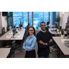 Two happy diverse professional executive business team people woman and African American man looking at camera standing in office lobby hall. Multicultural company managers team portrait. High-quality photo