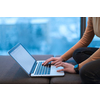 A young woman sitting in a modern space while working on a project on a laptop. Selective focus . High-quality photo
