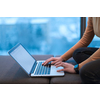 A young woman sitting in a modern space while working on a project on a laptop. Selective focus . High-quality photo