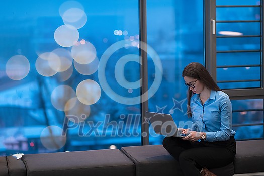 A young woman sitting in a modern space while working on a project on a laptop. Selective focus . High-quality photo A young woman sitting in a modern space while working on a project on a laptop. Selective focus . High-quality photo