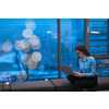 A young woman sitting in a modern space while working on a project on a laptop. Selective focus . High-quality photo