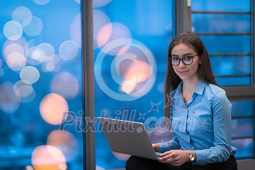 A young woman sitting in a modern space while working on a project on a laptop. Selective focus . High-quality photo