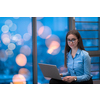 A young woman sitting in a modern space while working on a project on a laptop. Selective focus . High-quality photo