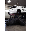 Car in a garage for maintenance, oil, tyre change (shallow DOF; color toned image)