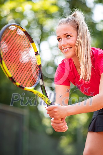 Pretty, young woman tennis player playing on a clay court. Healthy active lifestyle concept Pretty, young woman tennis player playing on a clay court. Healthy active lifestyle concept