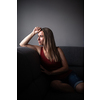 Mid-aged woman at home relaxing on a sofa (color toned image)