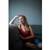 Mid-aged woman at home relaxing on a sofa (color toned image)