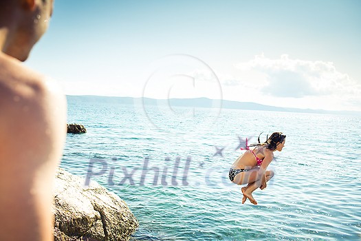 Young man having fun and taking a dive in the sea Young man having fun and taking a dive in the sea