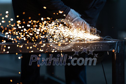 Man working on iron with grinder. Man at work. Sparkles and fire from grinder cutting. Grinder. Worker. Man working on iron with grinder. Man at work. Sparkles and fire from grinder cutting. Grinder. Worker.