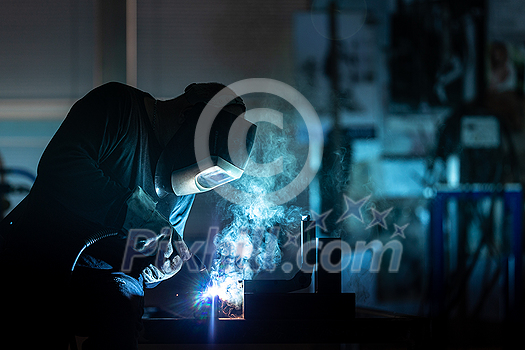 Man working on iron with grinder. Man at work. Sparkles and fire from grinder cutting. Grinder. Worker. Man working on iron with grinder. Man at work. Sparkles and fire from grinder cutting. Grinder. Worker.