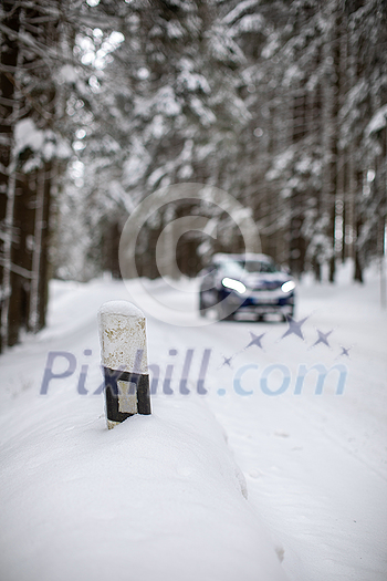 Car on a snowy winter road amid forests - using its four wheel drive capacities to get through the snow Car on a snowy winter road amid forests - using its four wheel drive capacities to get through the snow