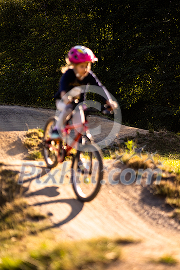 Little girl riding with her bike on a pumptrack Little girl riding with her bike on a pumptrack