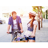 Happy young couple in city with bike